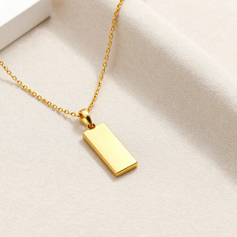 A gold-plated bar necklace on beige linen